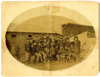 Oval photograph of Union officer (probably Alba M. Tucker) surrounded by his staff in Louisville, Ky.